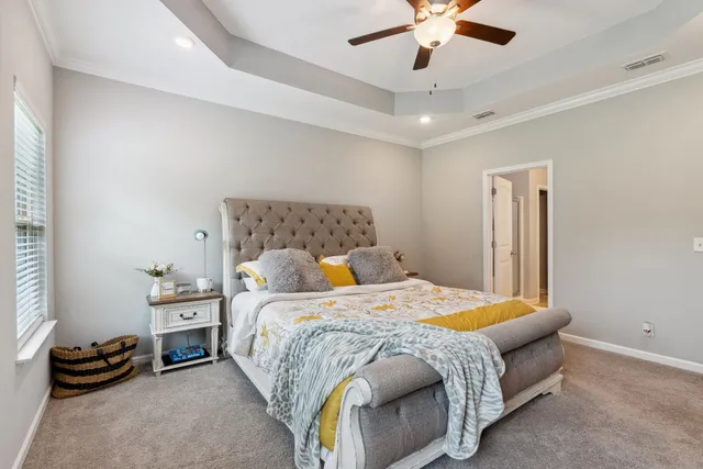 a bedroom with a bed and a chandelier