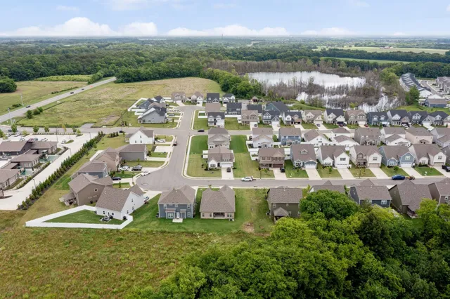 an aerial view of residential houses with outdoor space and river