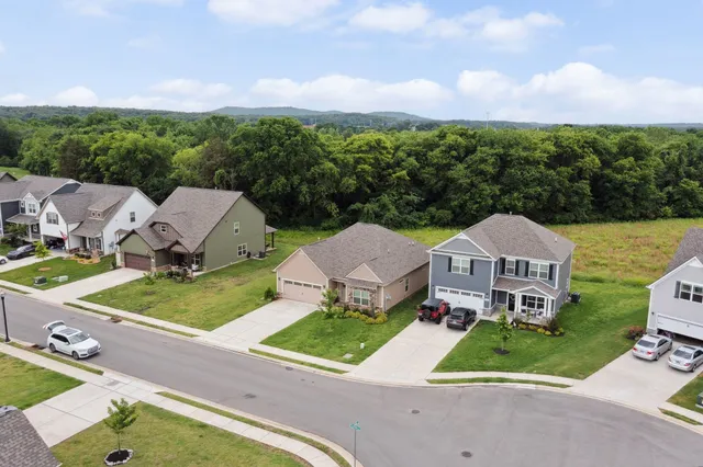 an aerial view of a house with a garden and trees