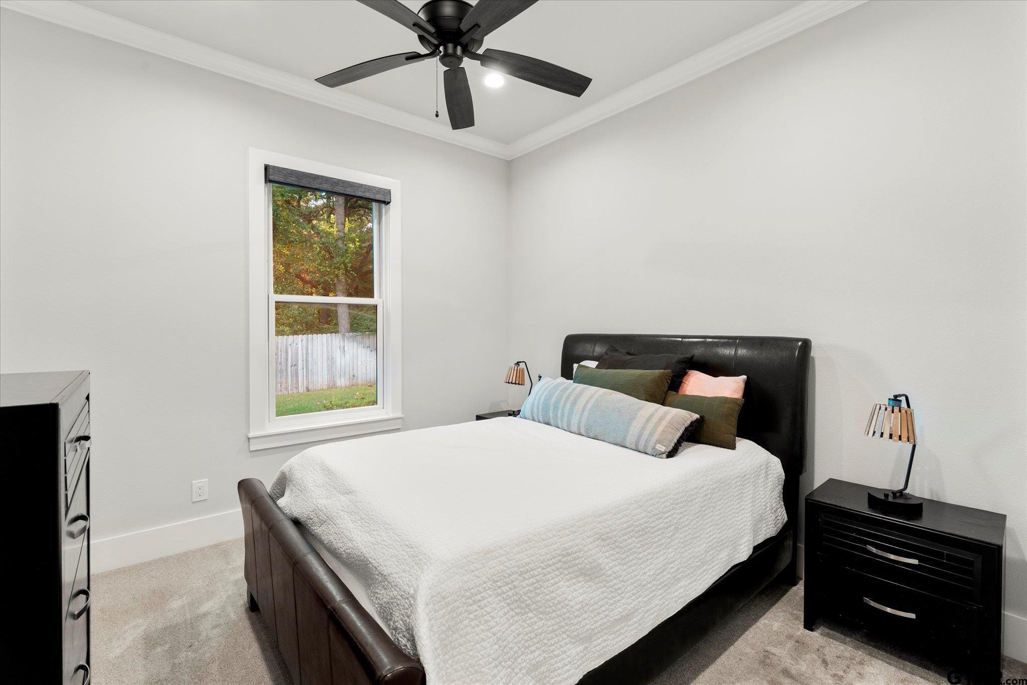 4301 Windrush Boulevard Longview, TX 75604 - Photo 19 of 36 a bedroom with a bed and a window