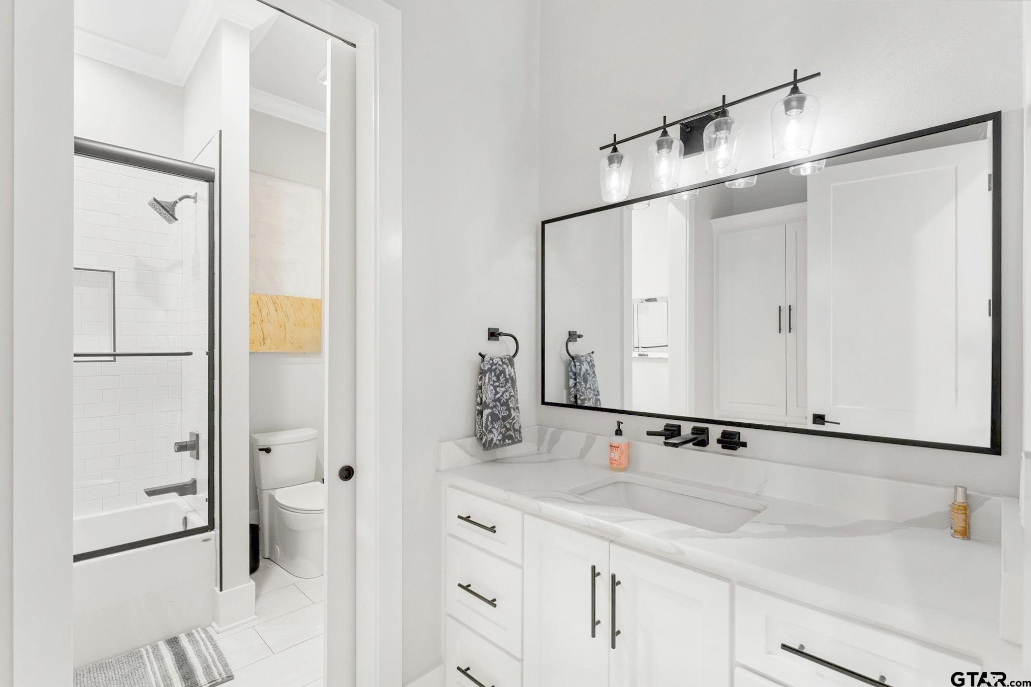4301 Windrush Boulevard Longview, TX 75604 - Photo 22 of 36 a bathroom with a sink and a mirror
