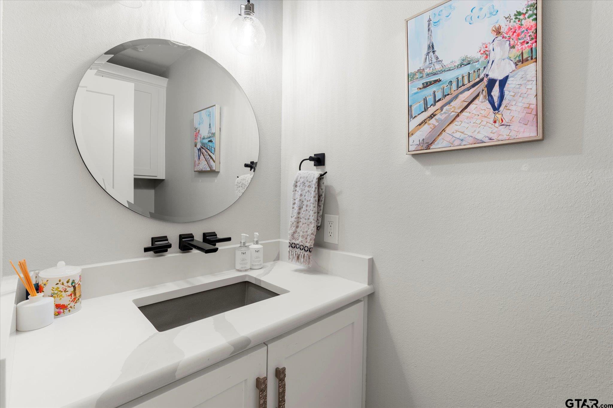 4301 Windrush Boulevard Longview, TX 75604 - Photo 23 of 36 a bathroom with a sink and a mirror