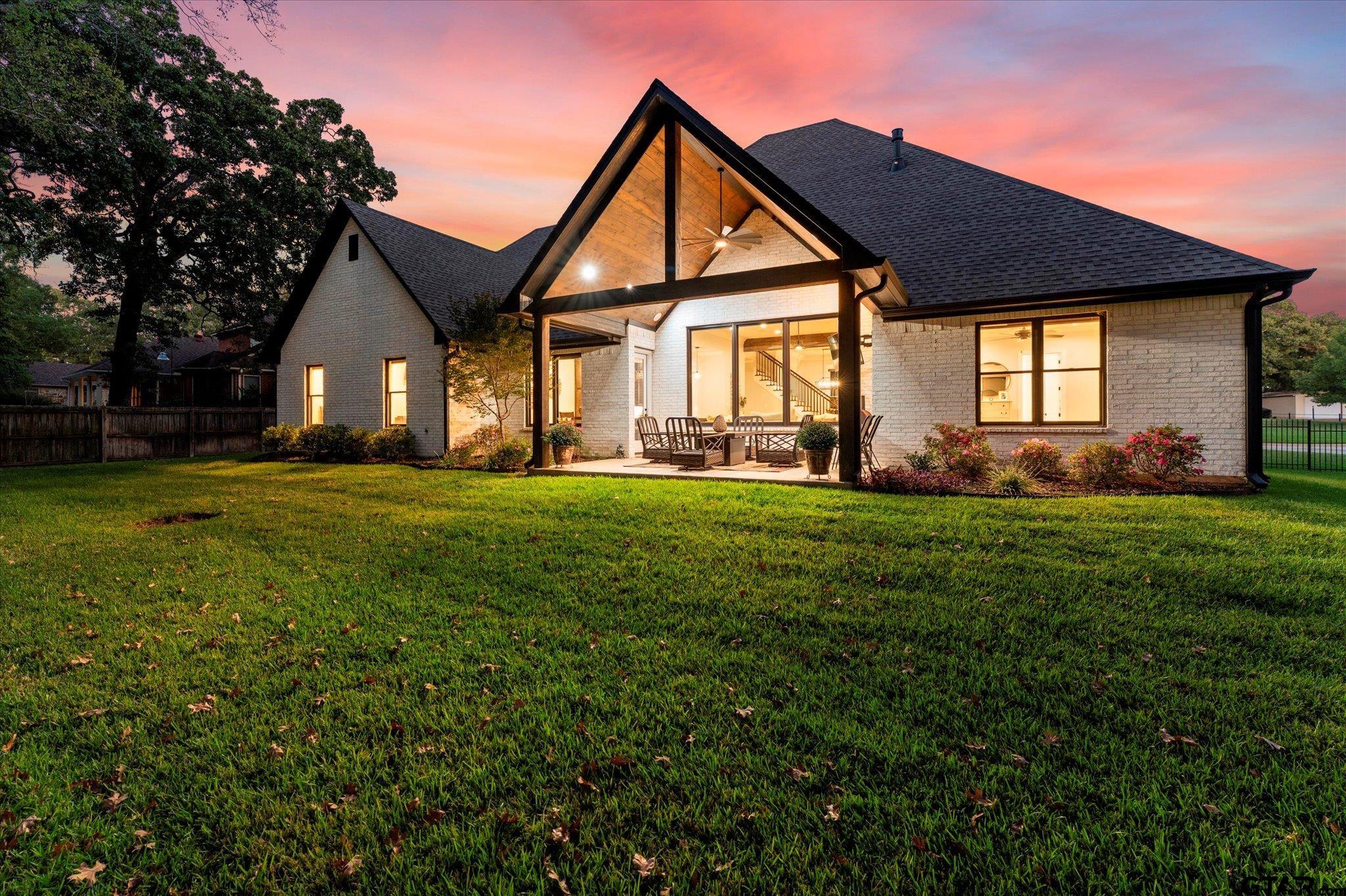 4301 Windrush Boulevard Longview, TX 75604 - Photo 31 of 36 a front view of a house with a yard and trees