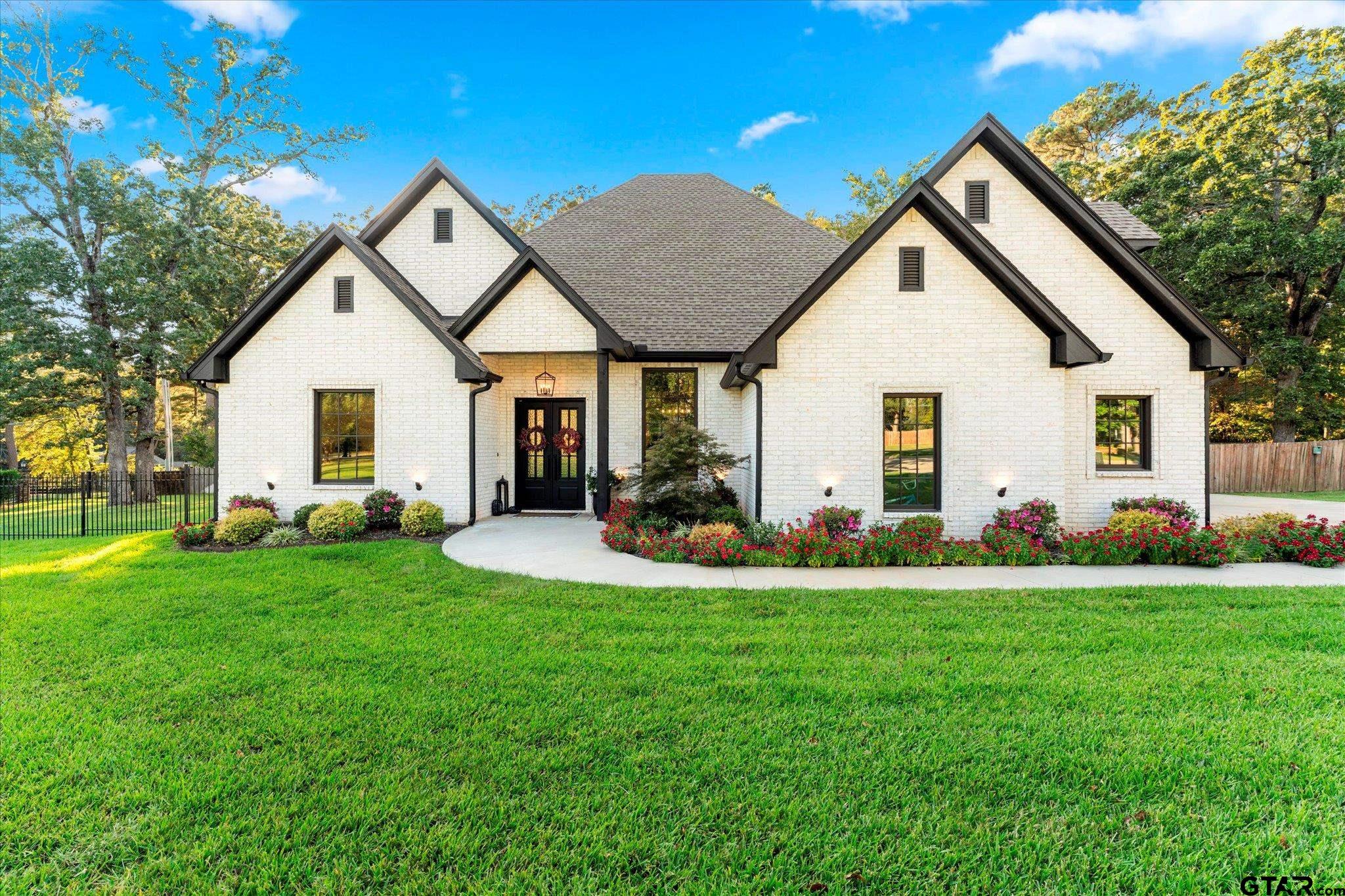 4301 Windrush Boulevard Longview, TX 75604 - Photo 33 of 36 a view of a house with a big yard and potted plants