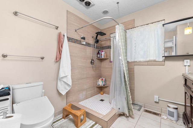 1489 North 400 West Bountiful, UT 84010 - Photo 18 of 47 Shower with light-toned rectangular tile surround, hexagonal floor tiles, and built-in shelving