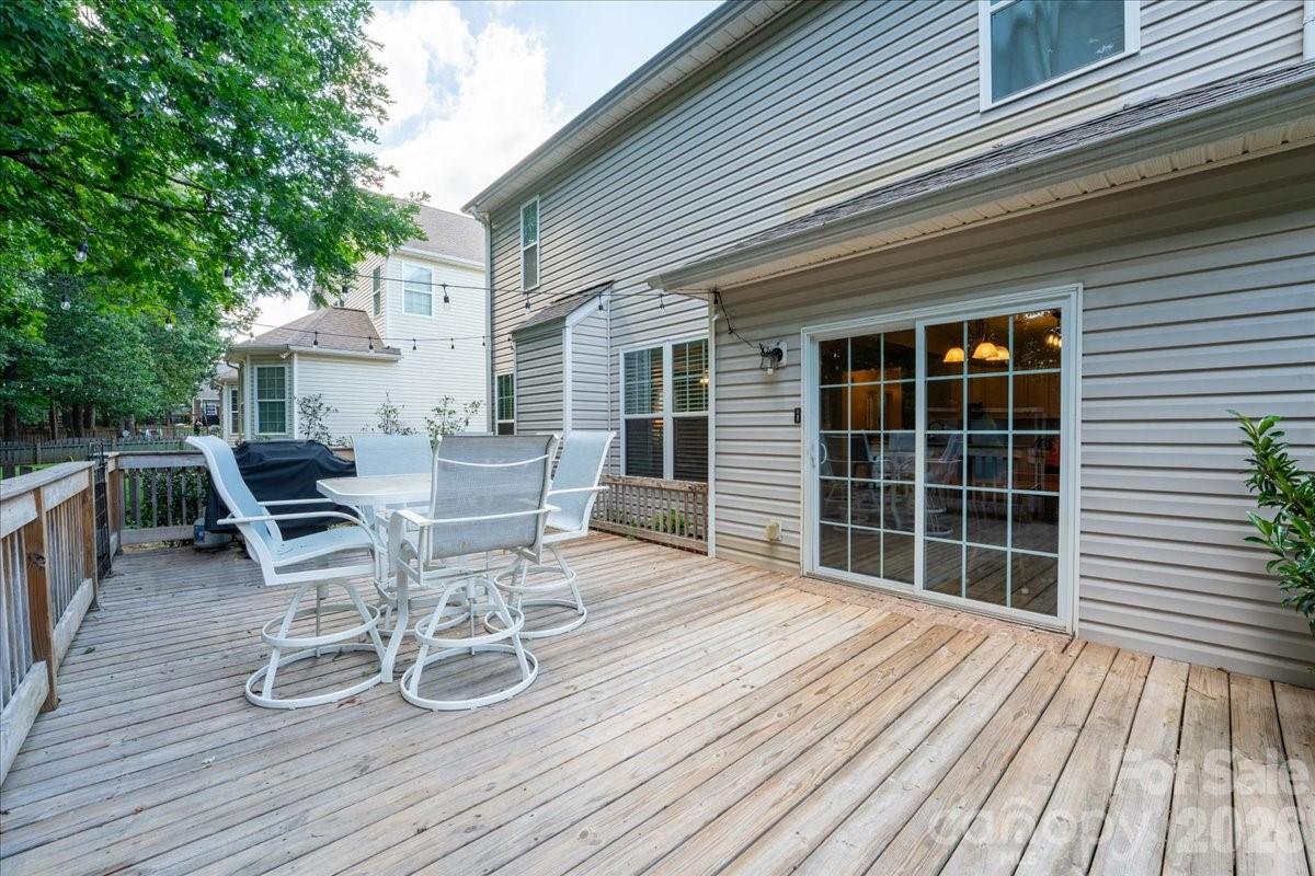 8006 Fine Robe Drive Indian Trail, NC 28079 - Photo 33 of 36 a view of a roof deck with table and chairs and wooden floor