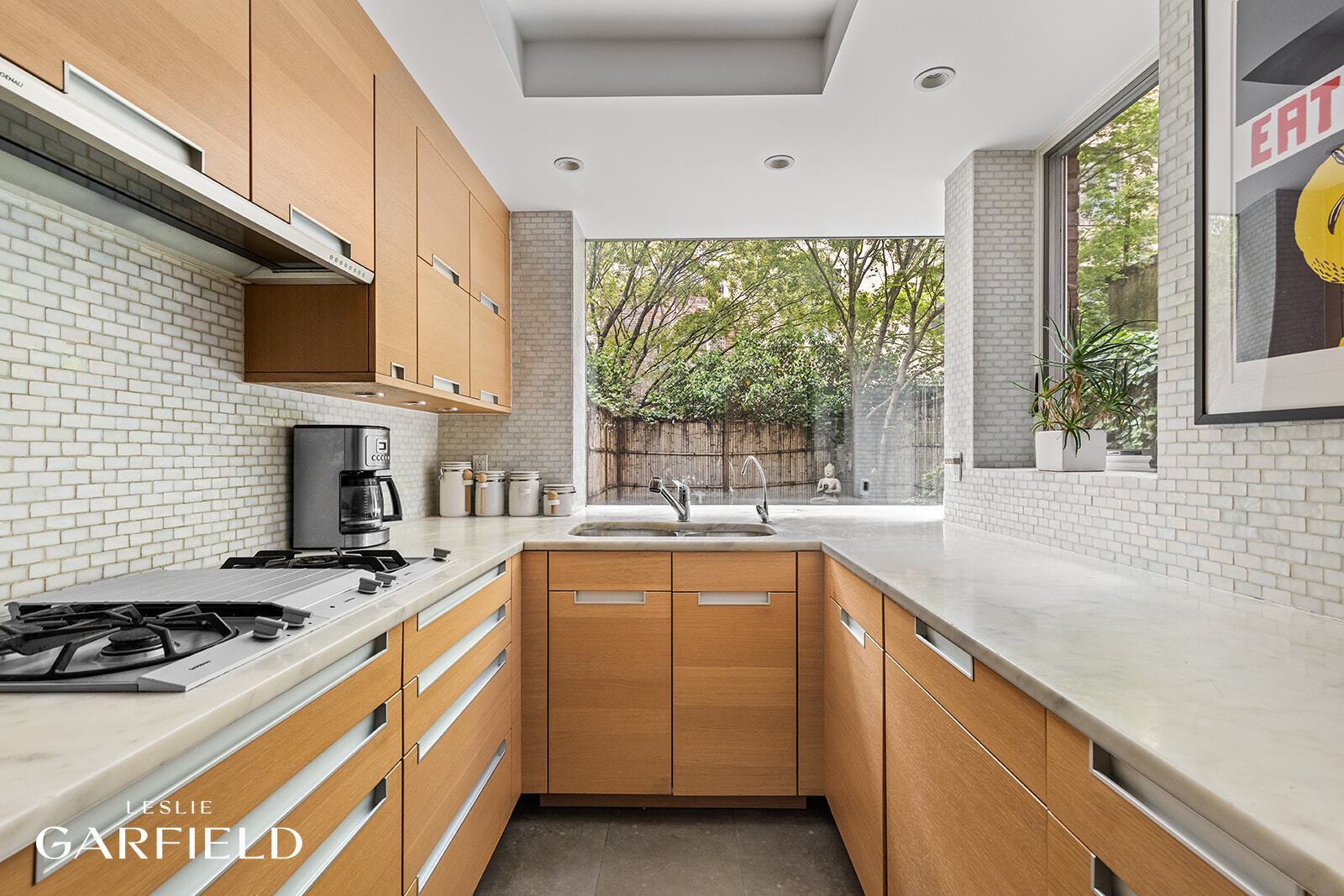 315 West 84th Street Manhattan, NY 10024 - Photo 5 of 20 a kitchen with a sink stove top oven and cabinets