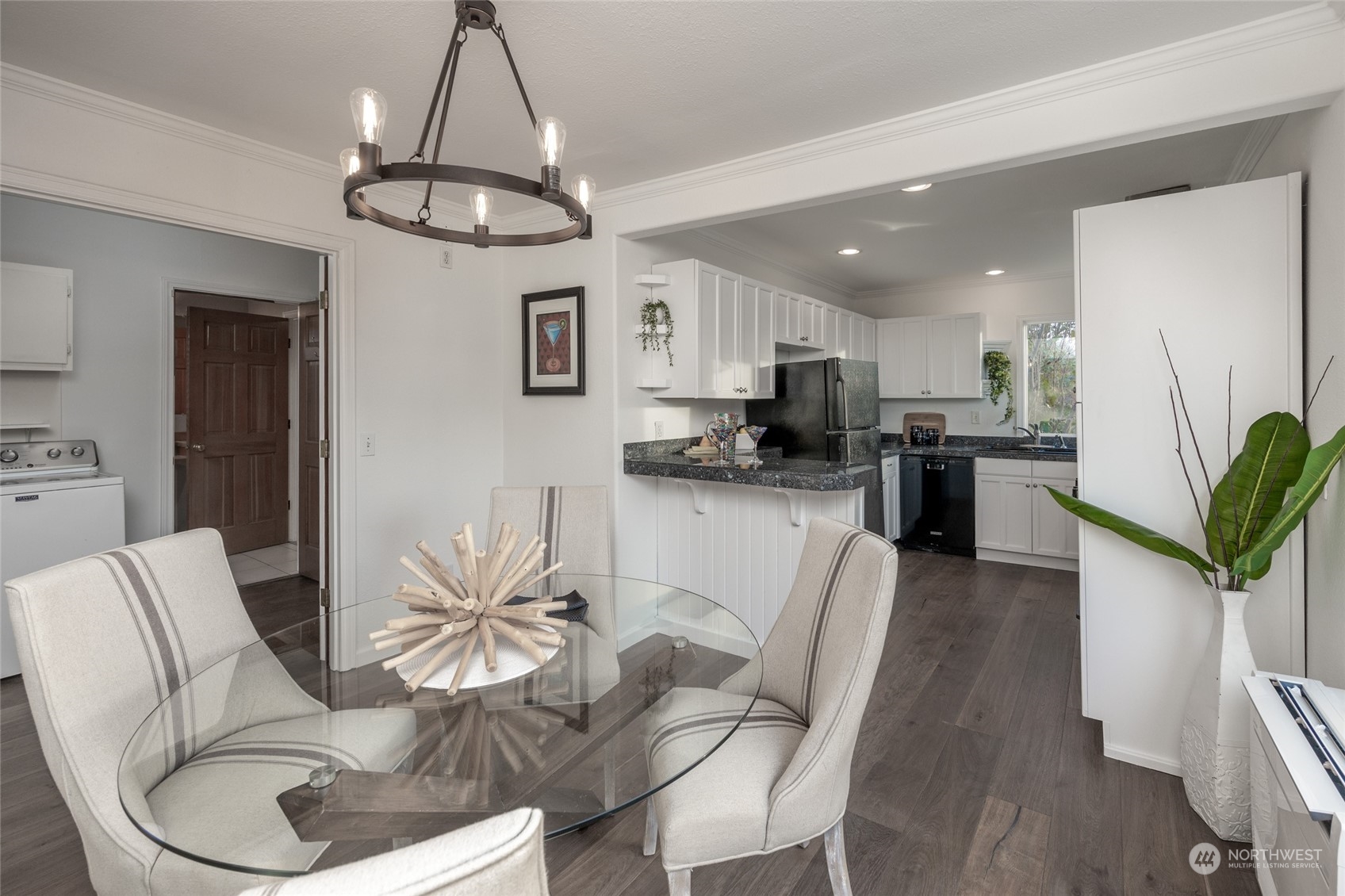 1508 Lake Avenue South Renton, WA 98055 - Photo 7 of 40 a kitchen with stainless steel appliances kitchen island granite countertop a refrigerator a stove a sink dishwasher a dining table and chairs with wooden floor