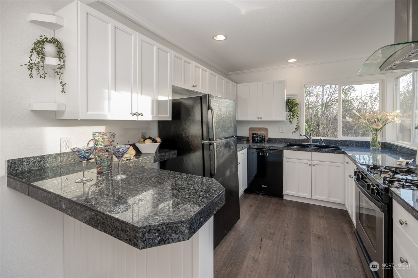 1508 Lake Avenue South Renton, WA 98055 - Photo 8 of 40 a kitchen with a sink a kitchen island a stove a refrigerator and cabinets