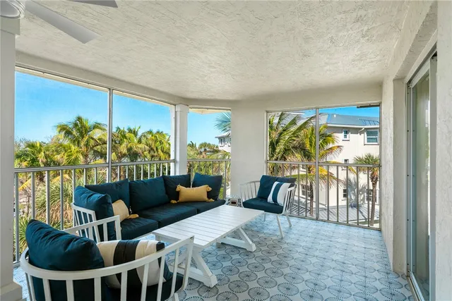 a living room with furniture a rug a lamp and a window