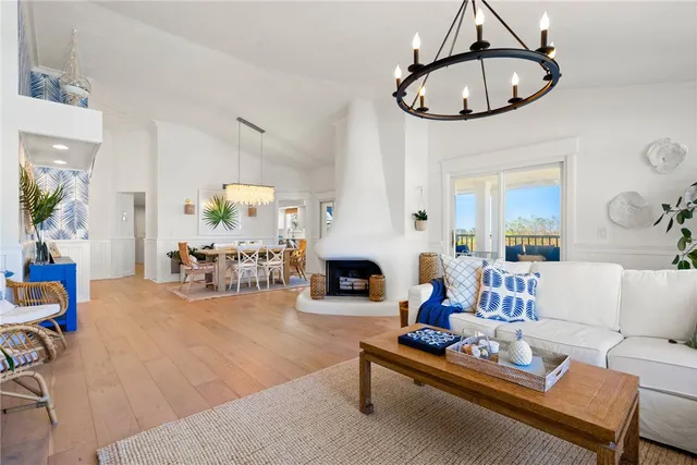 a living room with furniture a chandelier and a flat screen tv
