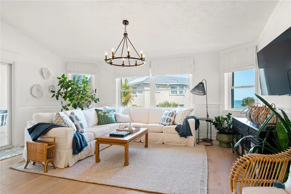 a living room with furniture a rug a lamp and a window