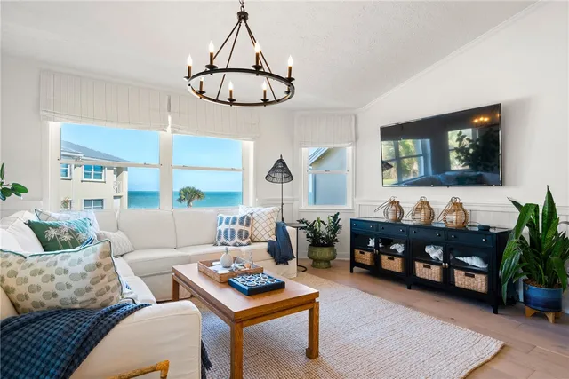 a spacious bedroom with a bed and a chandelier