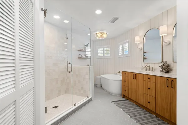 a bathroom with a double vanity sink mirror and toilet
