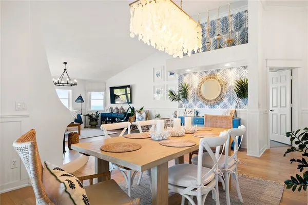 a view of a dining room with furniture and a chandelier