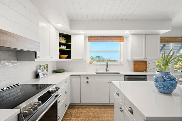 a kitchen with a sink stove and cabinets