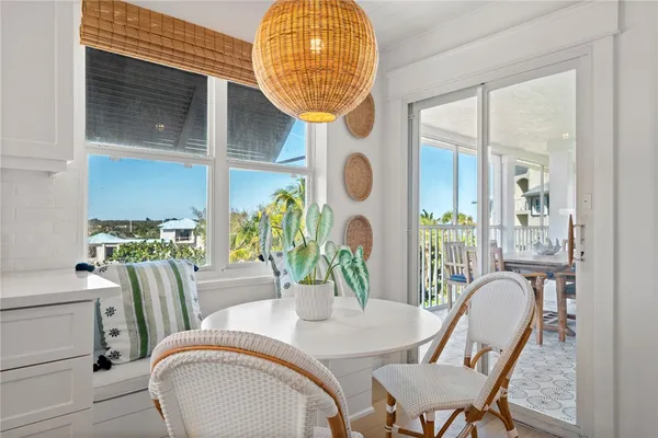 a dining room with furniture and wooden floor