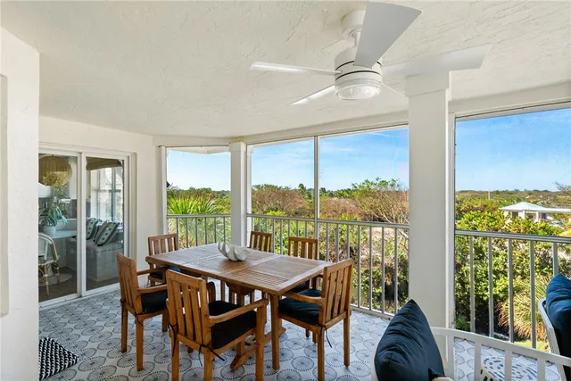 a view of a dining room with furniture and a potted plant