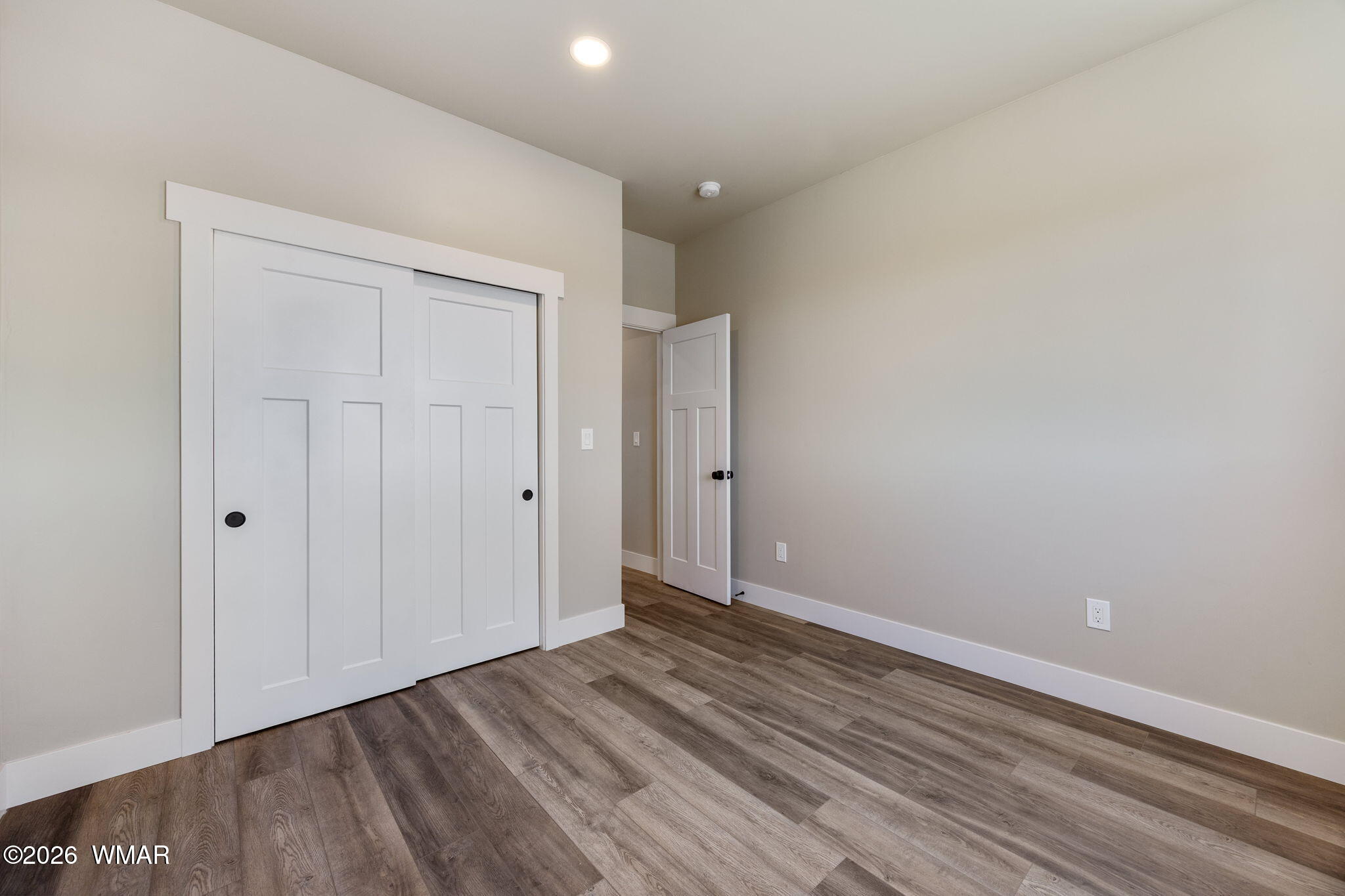 561 South Rock Ridge Drive Show Low, AZ 85901 - Photo 18 of 28 a view of an empty room with closet and wooden floor
