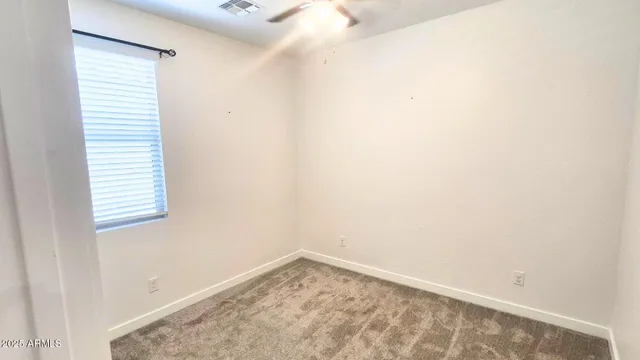 a view of a small space with wooden floor and a window
