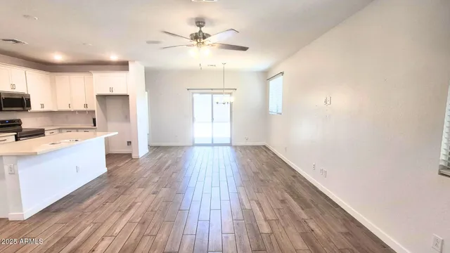 a view of a kitchen with wooden floor and a kitchen