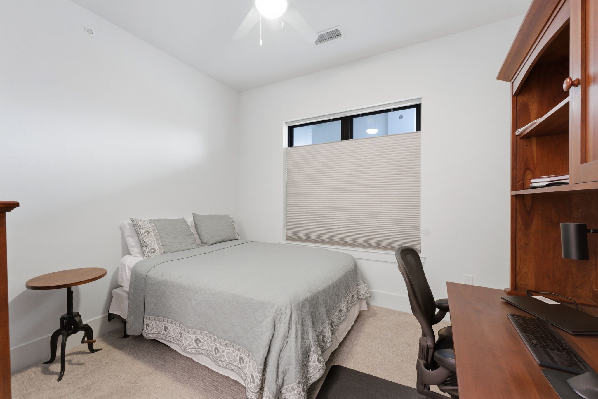 199 Waterpoint Court, Unit 202 Conroe, TX 77304 - Photo 28 of 41 a bedroom with a bed and a desk