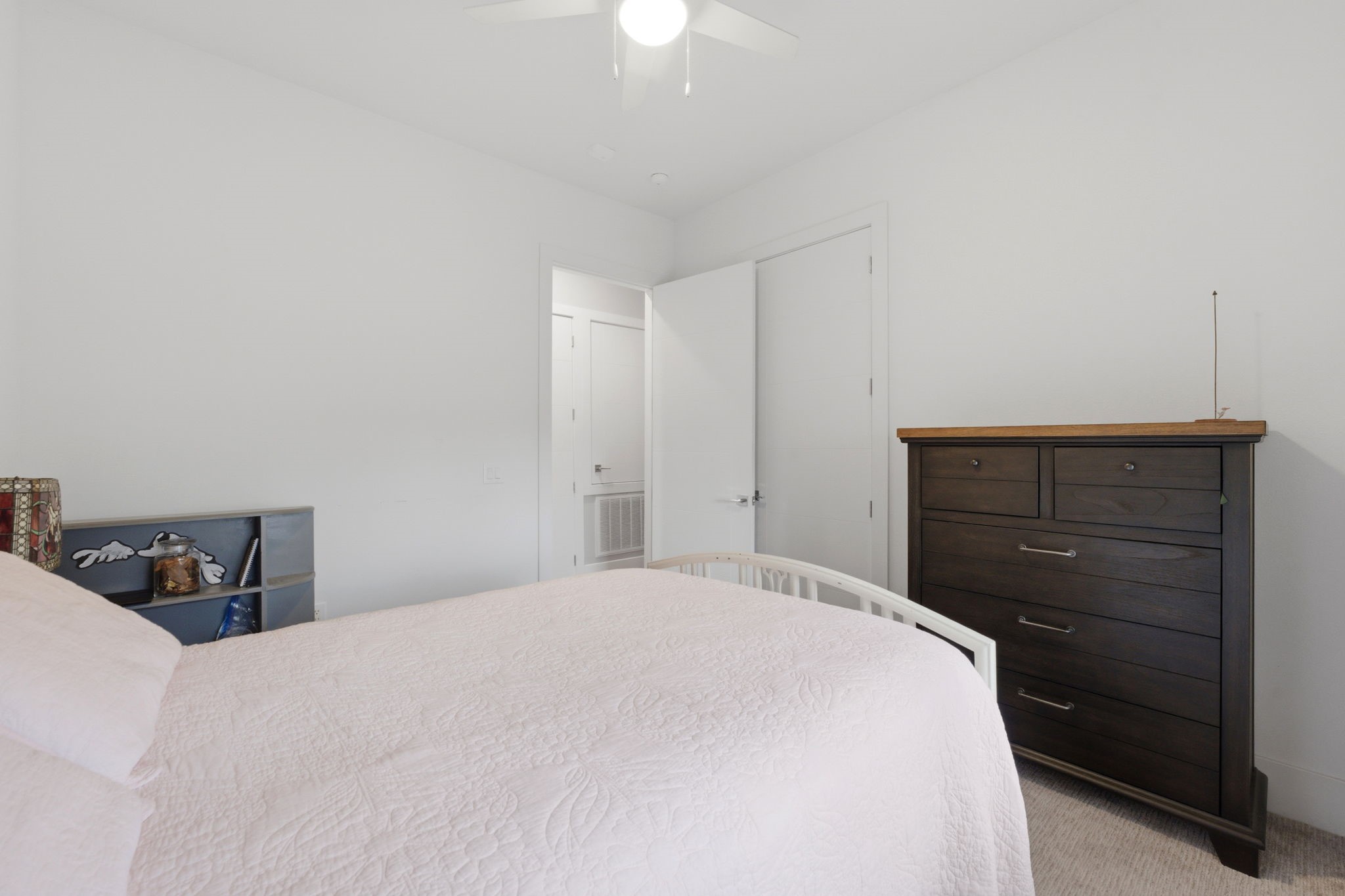 199 Waterpoint Court, Unit 202 Conroe, TX 77304 - Photo 31 of 41 a bedroom with a bed and a dresser