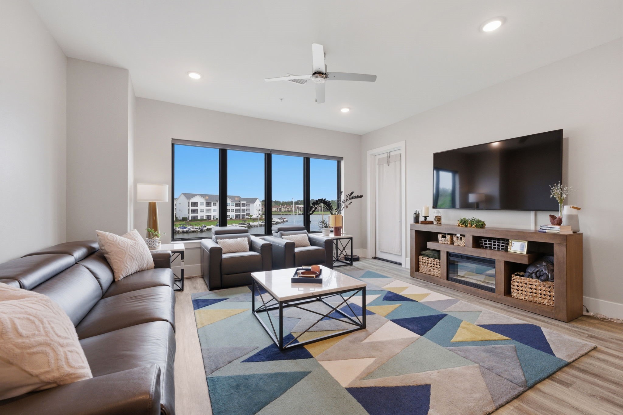 199 Waterpoint Court, Unit 202 Conroe, TX 77304 - Photo 6 of 41 a living room with furniture and a flat screen tv