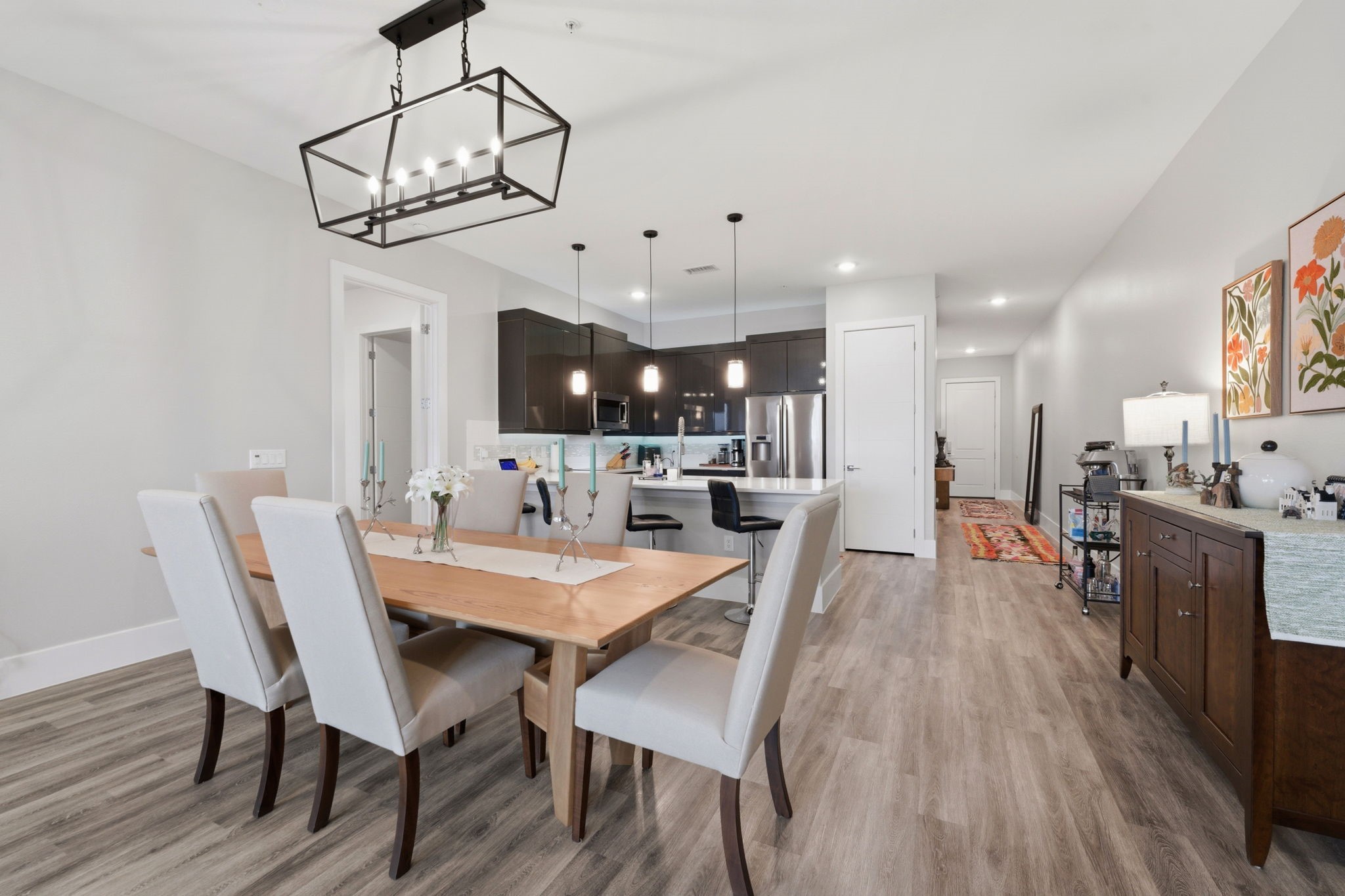 199 Waterpoint Court, Unit 202 Conroe, TX 77304 - Photo 9 of 41 a view of a dining room with furniture wooden floor and chandelier