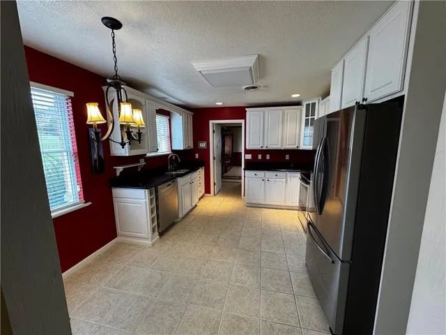 a kitchen with a refrigerator and a sink