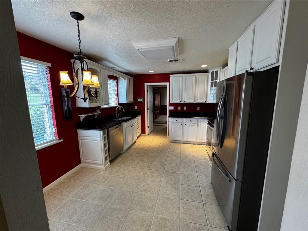 105 Patty Drive Uniontown, PA 15401 - Photo 12 of 25 a kitchen with stainless steel appliances granite countertop a refrigerator a sink and a stove