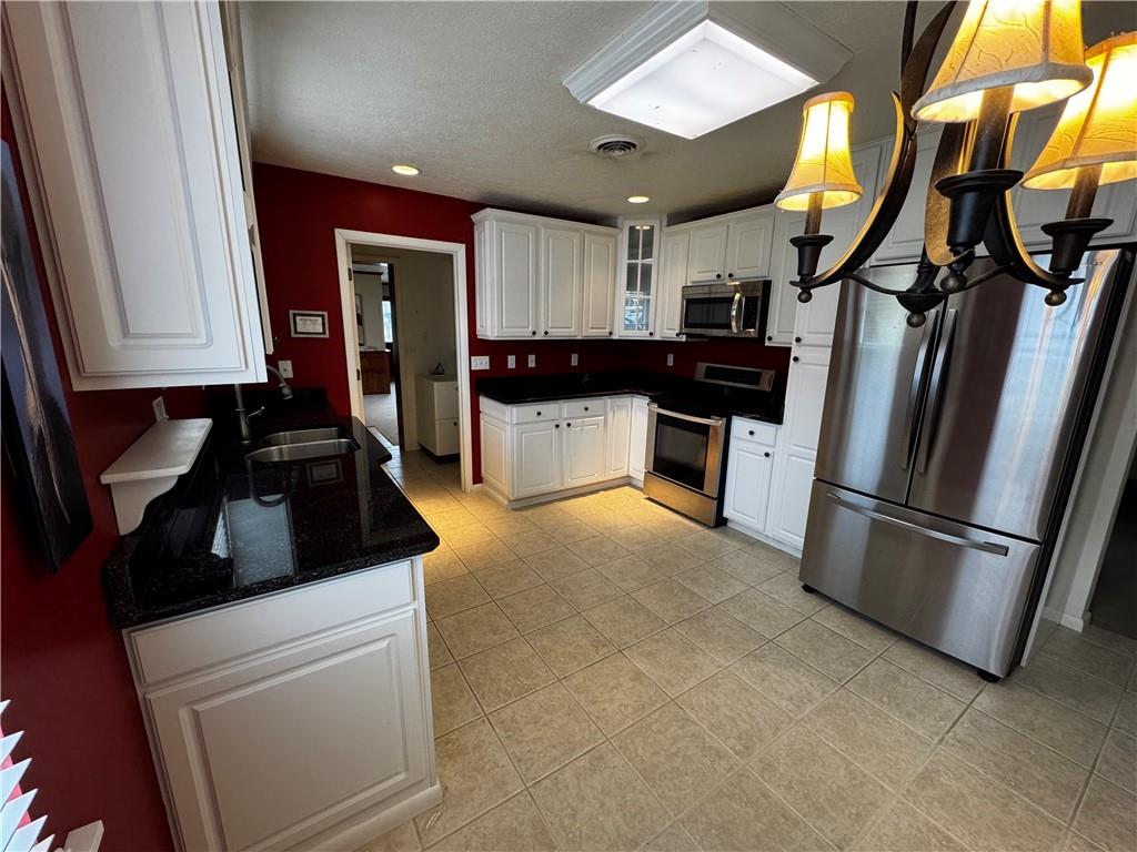 105 Patty Drive Uniontown, PA 15401 - Photo 13 of 25 a kitchen with a refrigerator and a sink