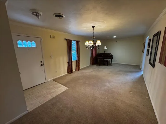 an empty room with a empty space and windows