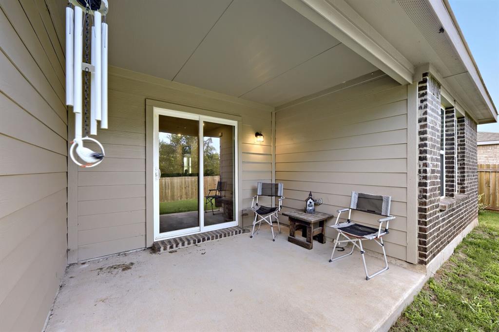 420 Jameson Springtown, TX 76082 - Photo 27 of 29 a view of a patio with table and chairs and floor to ceiling window