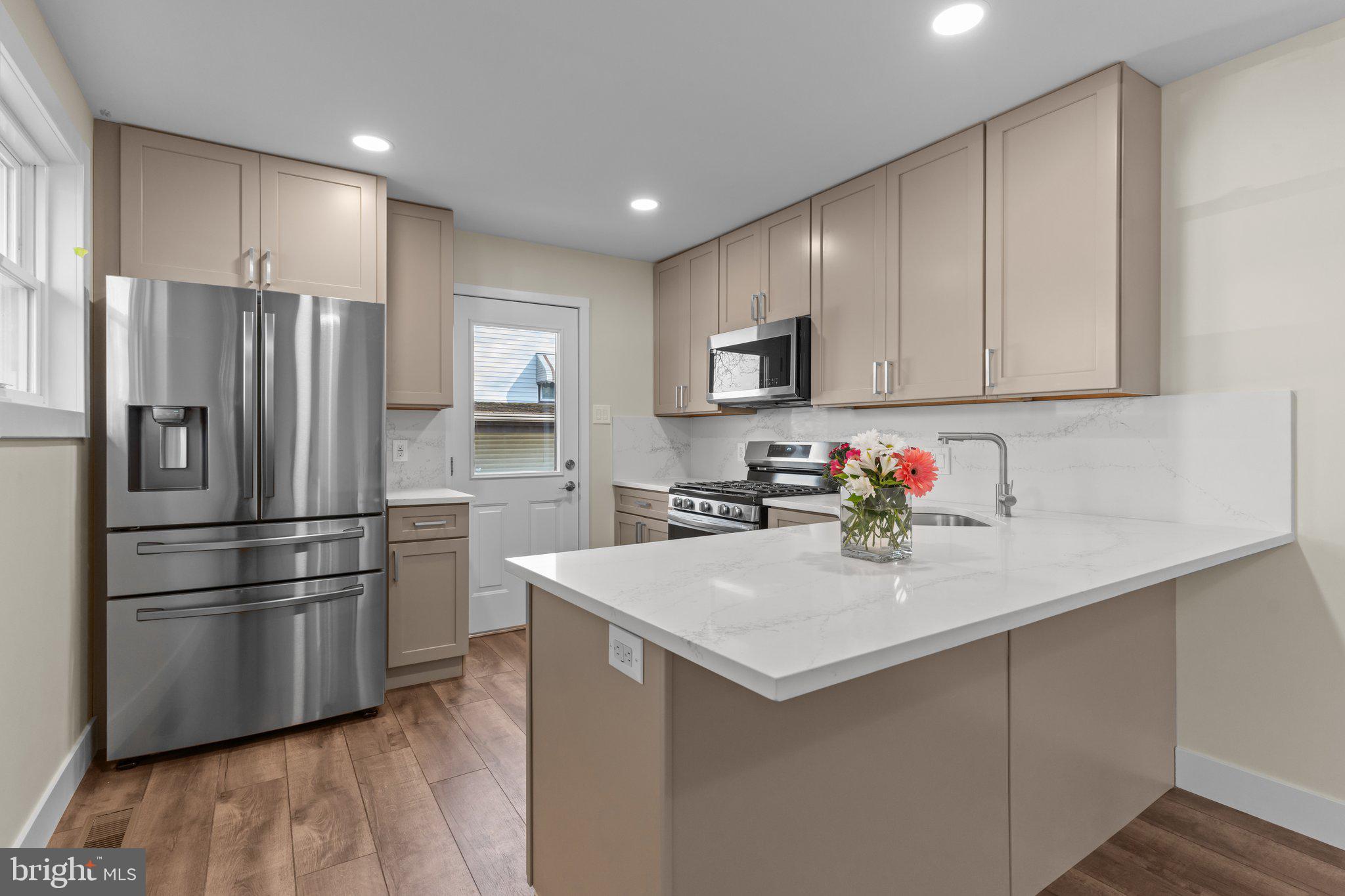 686 Spruce Road Warminster, PA 18974 - Photo 1 of 38 a kitchen with kitchen island a sink stainless steel appliances and refrigerator