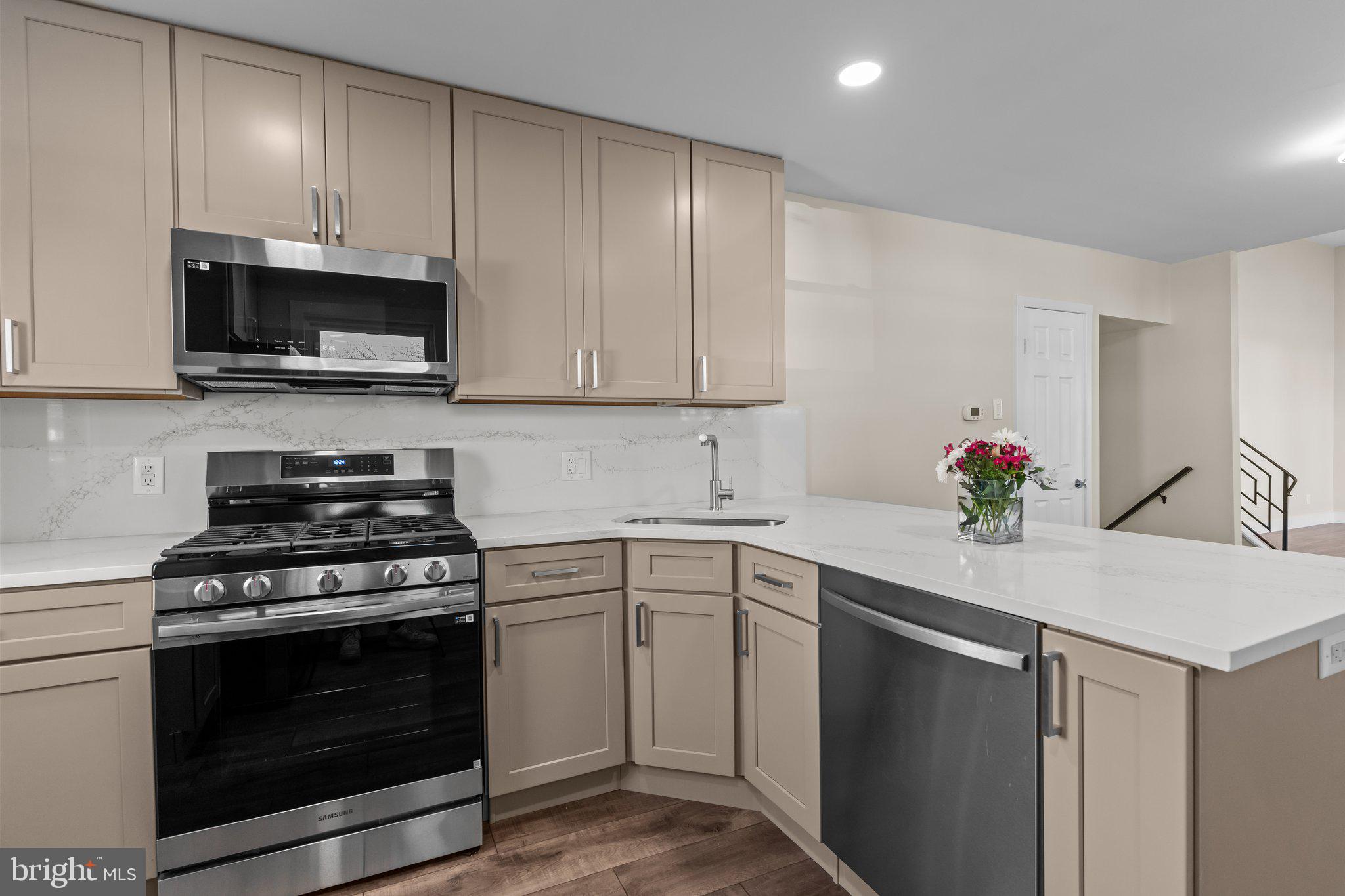 686 Spruce Road Warminster, PA 18974 - Photo 12 of 38 a kitchen with cabinets stainless steel appliances and wooden cabinets
