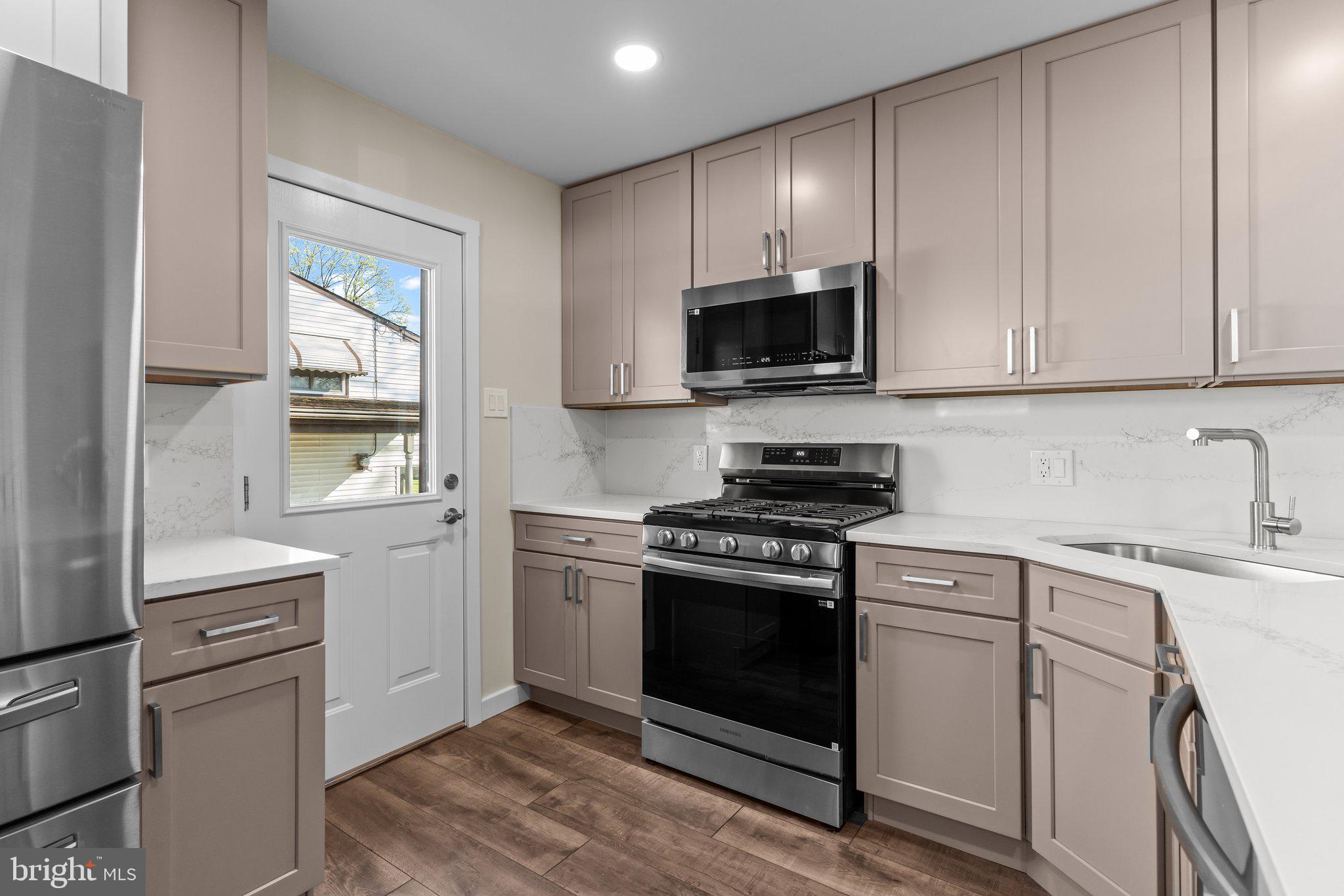 686 Spruce Road Warminster, PA 18974 - Photo 13 of 38 a kitchen with cabinets stainless steel appliances and wooden floor