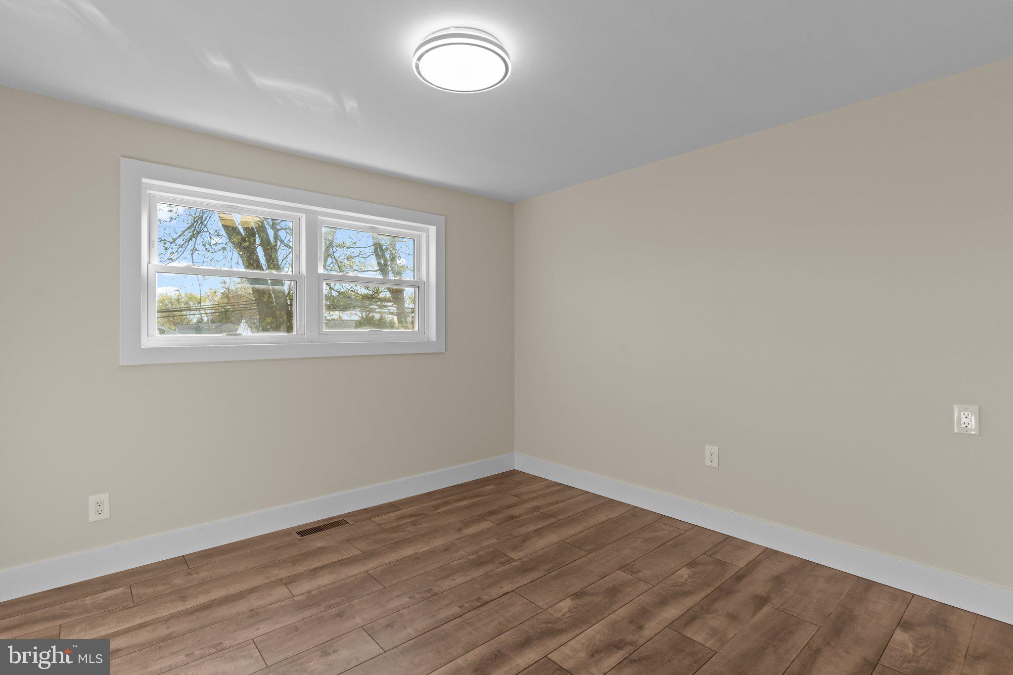 686 Spruce Road Warminster, PA 18974 - Photo 19 of 38 an empty room with wooden floor and windows