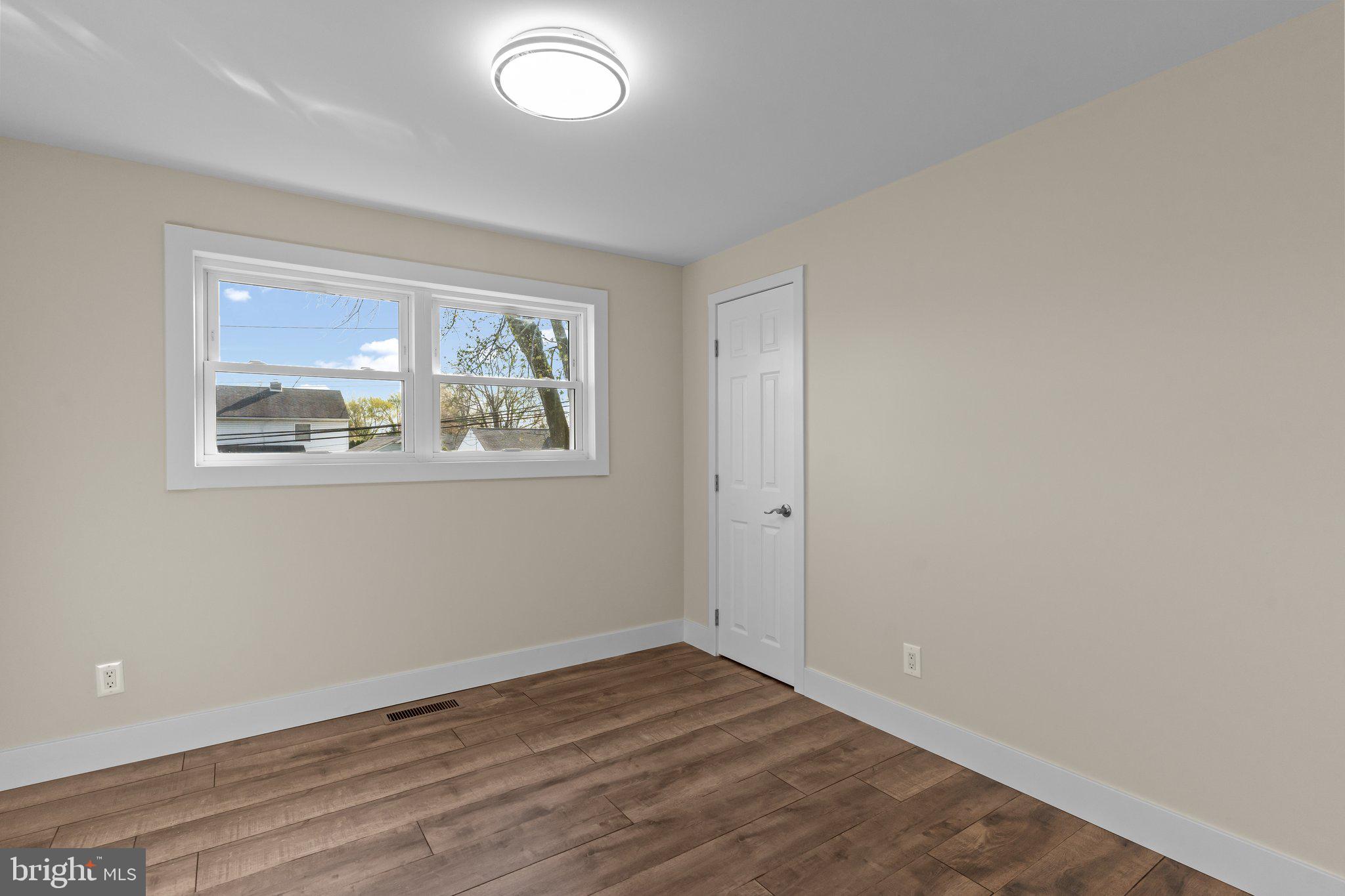 686 Spruce Road Warminster, PA 18974 - Photo 20 of 38 an empty room with wooden floor and window