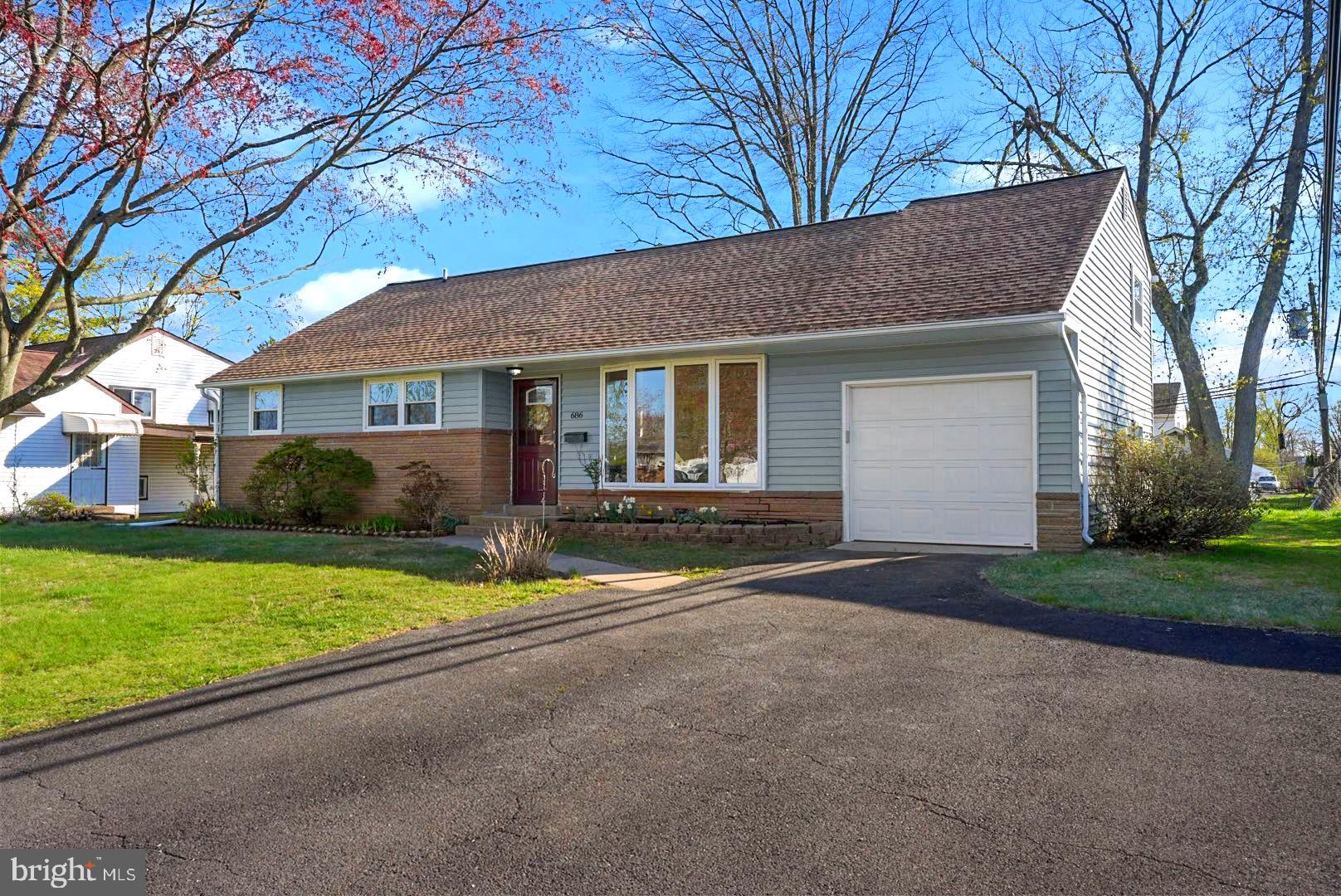 686 Spruce Road Warminster, PA 18974 - Photo 2 of 38 a front view of a house with a yard and garage