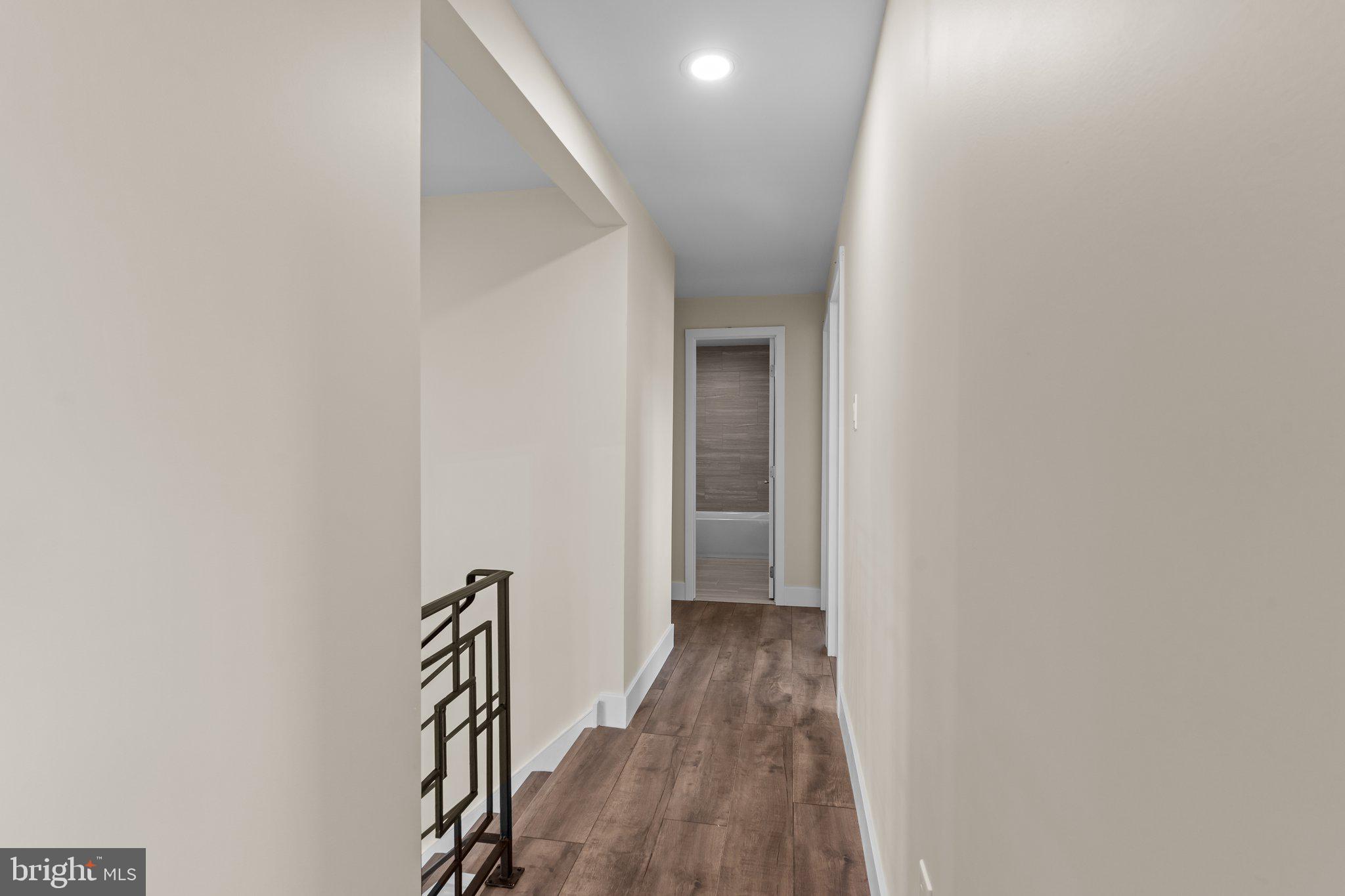 686 Spruce Road Warminster, PA 18974 - Photo 22 of 38 a view of a hallway with wooden floor and staircase