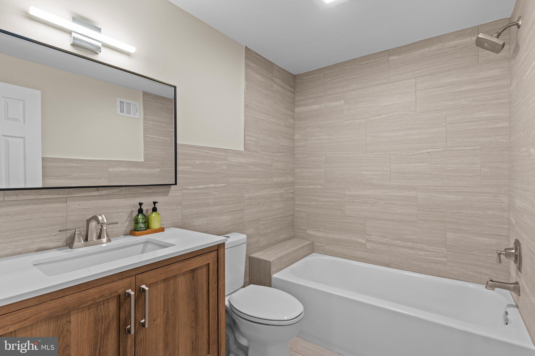 686 Spruce Road Warminster, PA 18974 - Photo 23 of 38 a bathroom with a granite countertop sink a toilet and bathtub