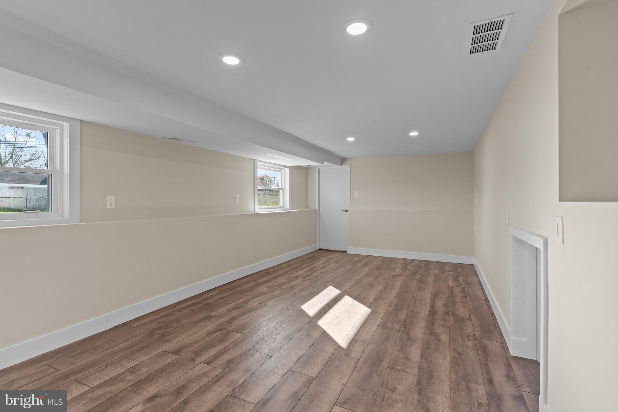 686 Spruce Road Warminster, PA 18974 - Photo 25 of 38 an empty room with wooden floor and windows