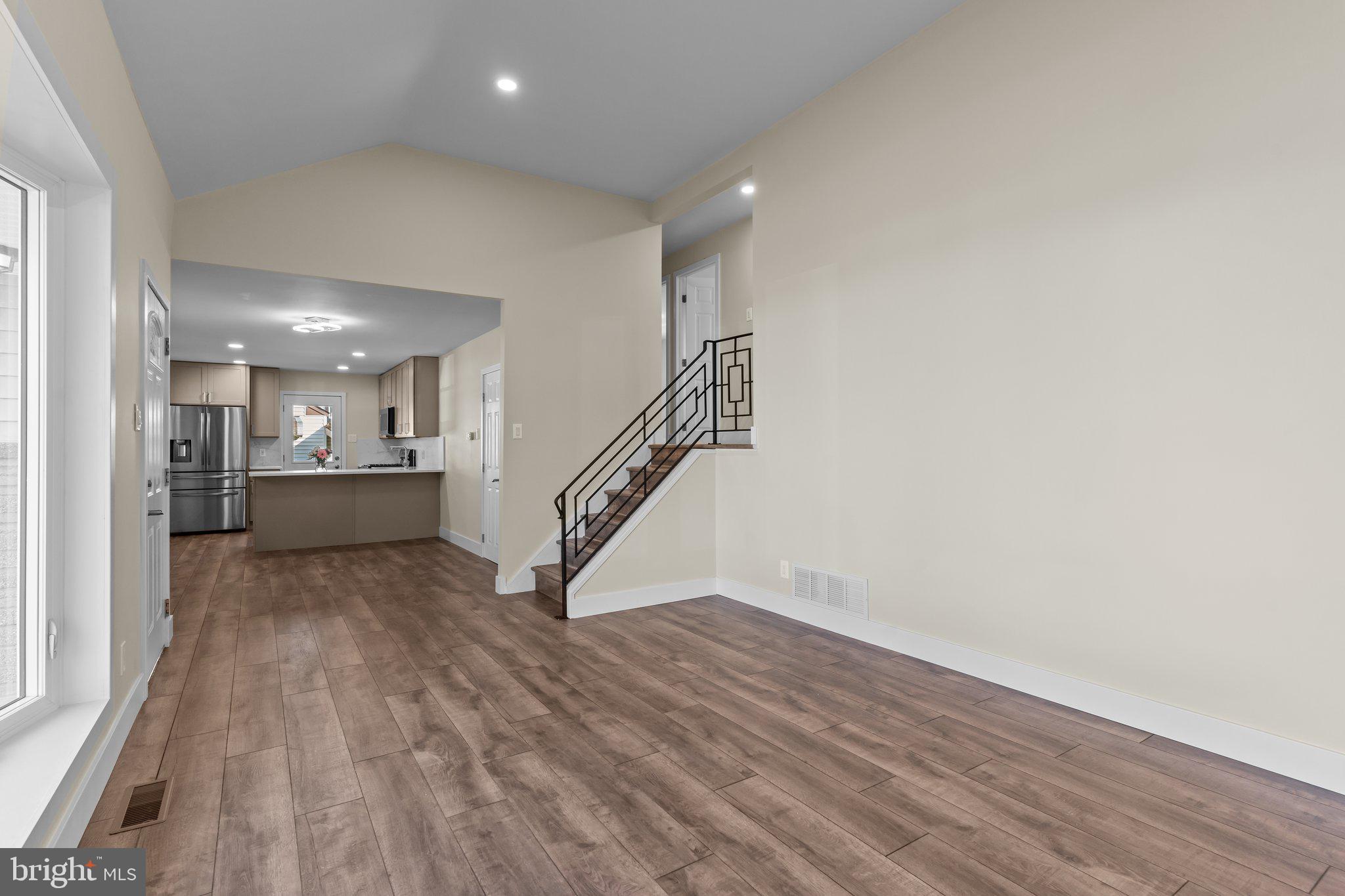 686 Spruce Road Warminster, PA 18974 - Photo 7 of 38 a view of a hallway with wooden floor and a kitchen