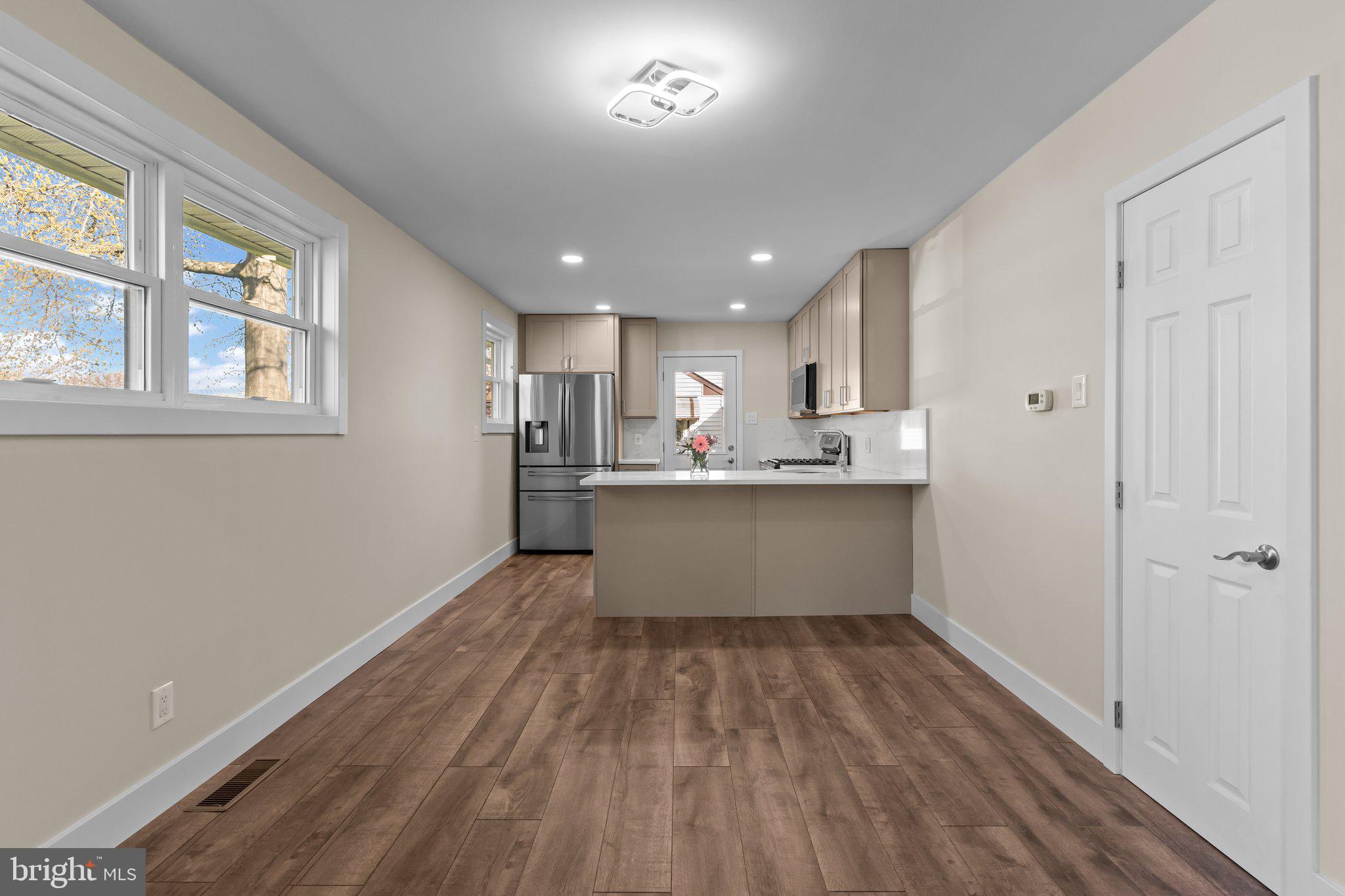 686 Spruce Road Warminster, PA 18974 - Photo 8 of 38 a room with stainless steel appliances kitchen island wooden floors and center island