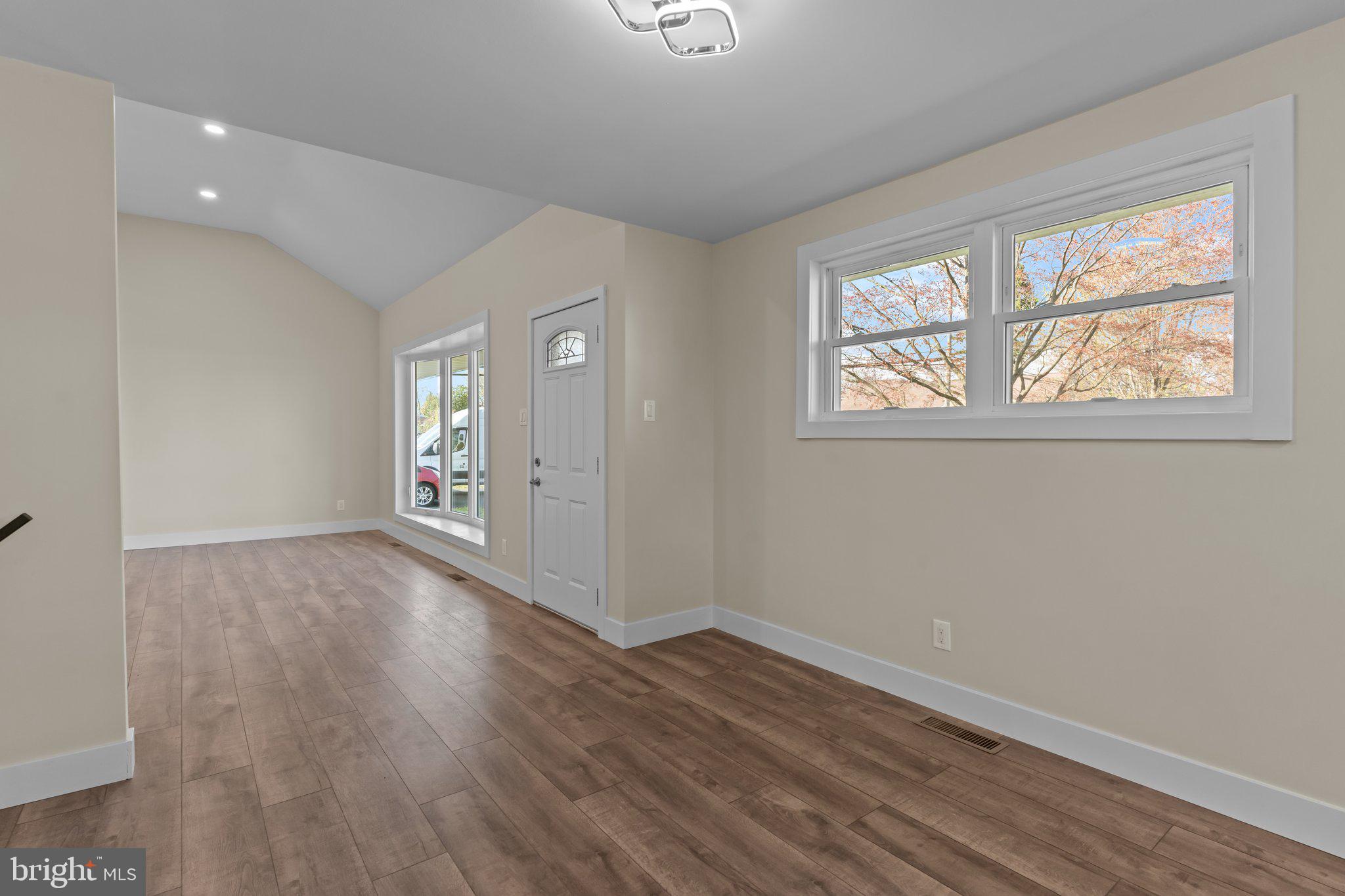 686 Spruce Road Warminster, PA 18974 - Photo 10 of 38 an empty room with wooden floor and windows