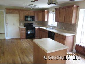 600 Oak Ridge Drive Clyde, NC 28721 - Photo 17 of 24 a kitchen with a sink a microwave a refrigerator and cabinets