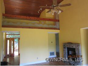 600 Oak Ridge Drive Clyde, NC 28721 - Photo 8 of 24 a view of a fireplace with a ceiling fan
