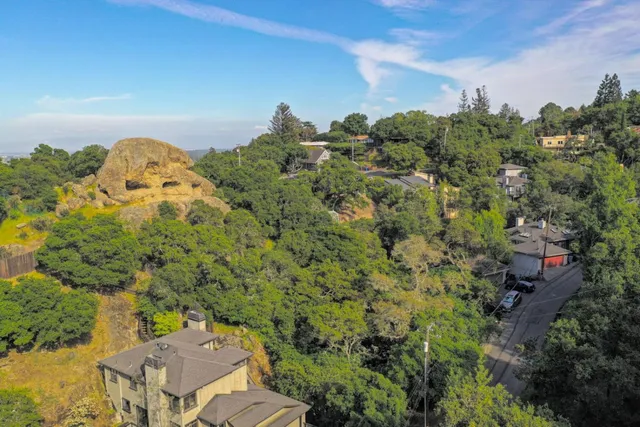 an aerial view of a house with a yard