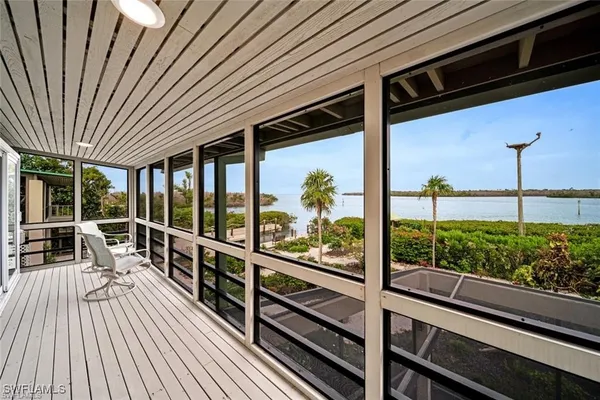 a view of a balcony with chairs